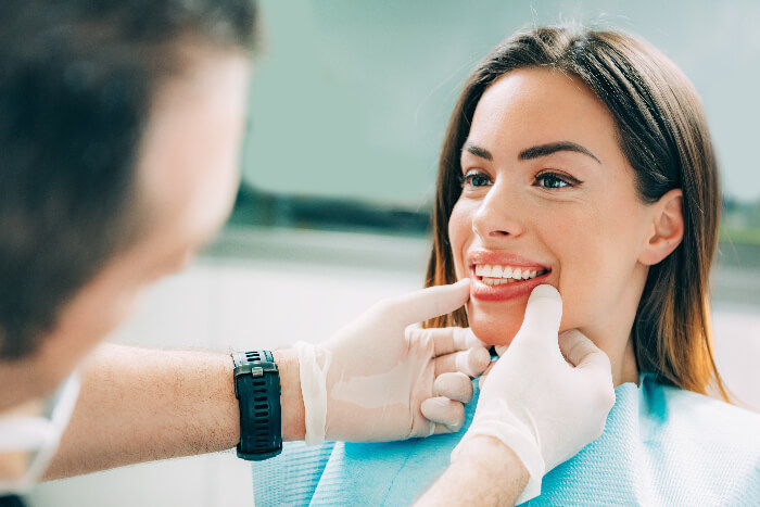 Dentist checks patient after Botox treatment
