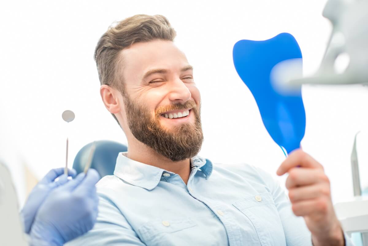 Man looking at his white Teeth.